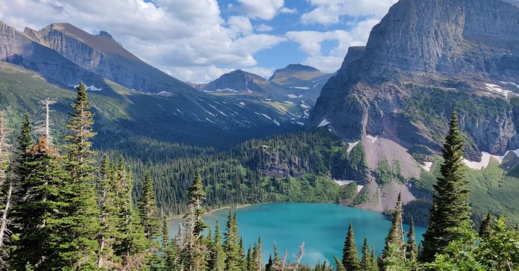 Breathtaking view of a mountain lake surrounded by forest in Glacier National Park, Montana.